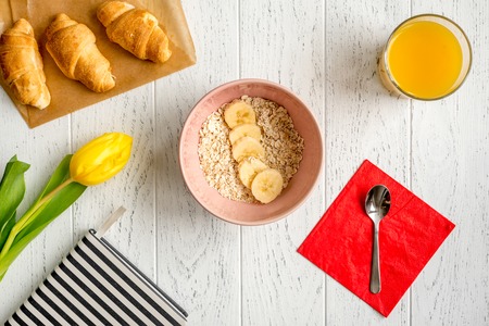 healthy breakfast with porridge on wooden background top view.