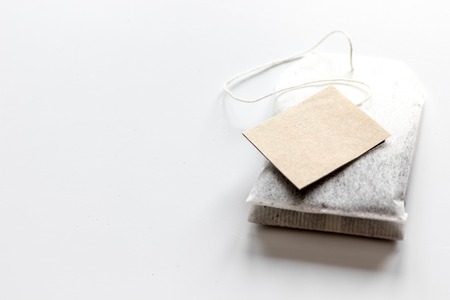 Close up black tea in teabag on white table background mock-upの写真素材