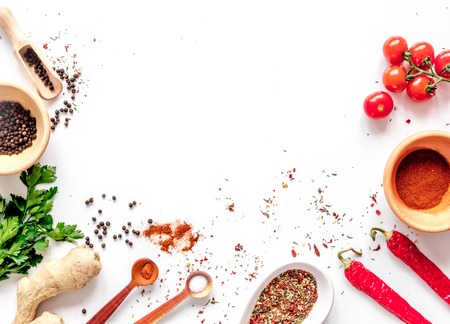 spices in wooden spoon on white background top view.の写真素材