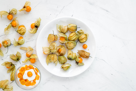 yogurt with physalis on stone background top viewの写真素材