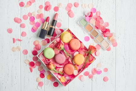 flowers and macaroon on wooden background top view patternの写真素材