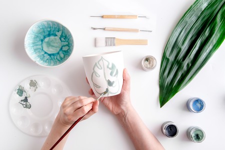painted ceramic cup on white background top viewの写真素材