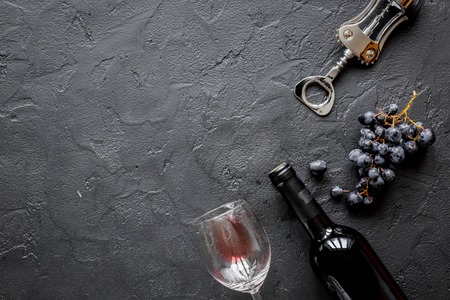Glass bottle of wine with grapes on stone top view mock upの写真素材