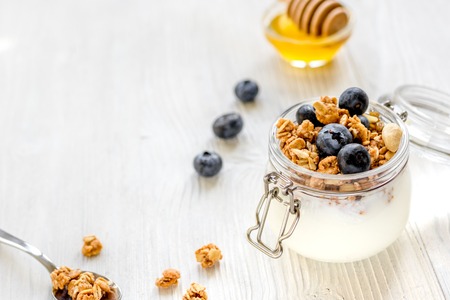 Homemade granola with blueberries in jar on white kitchen backgroundの写真素材