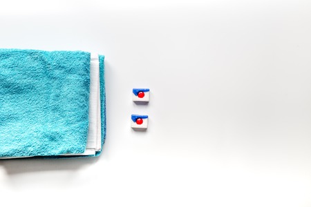 Pile of towels with detergent on white background top view mock upの写真素材