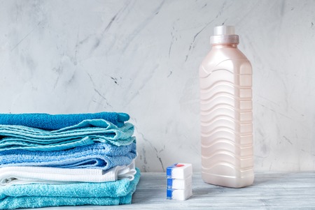 Pile of towels with detergent on laundry background mock upの写真素材