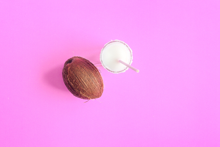 cocktail with coconut on purple background top viewの写真素材