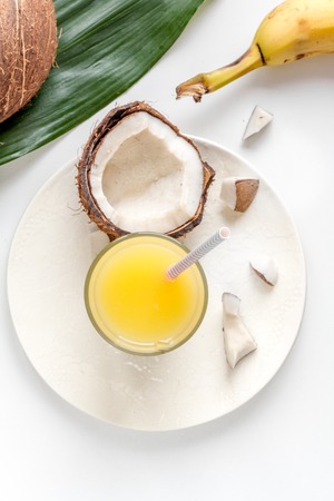 cocktail with coconut on white background top view