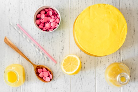 cooking lemon cake top view on wooden backgroundの写真素材