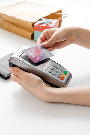 Present purchase with payment by card on white backgroundの写真素材