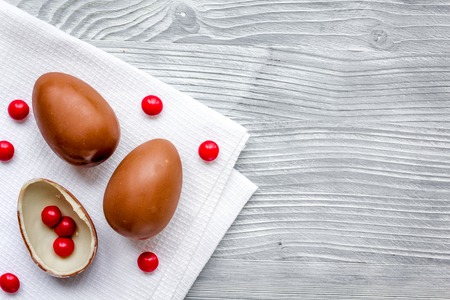 Easter chocolate eggs top view on wooden background mock up