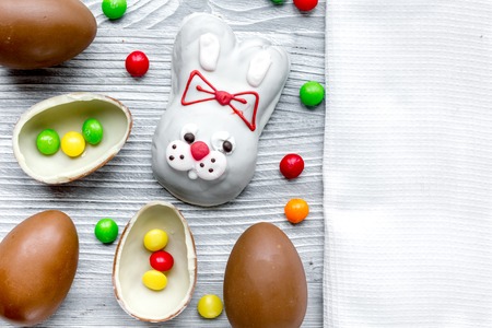Easter chocolate eggs top view on wooden background mock up