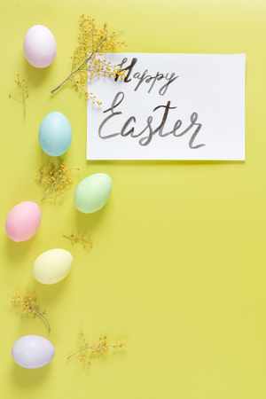 Easter concept on yellow background top view mockupの写真素材