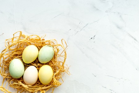 Easter concept eggs in nest top view close up