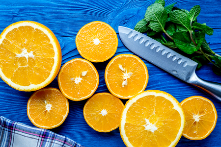 homemade orange and mint smoothie making on blue wooden table background top viewの写真素材