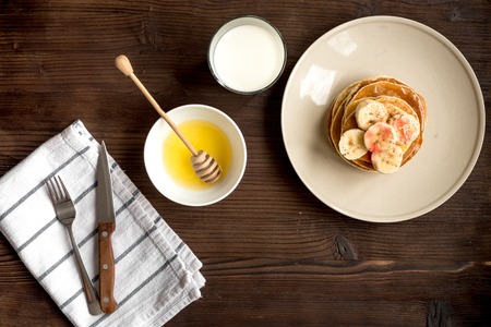 cooked pancake on plate top view at wooden backgroundの写真素材