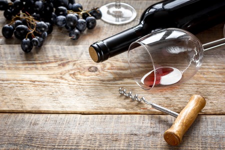 restaurant set with wine bottle and grape on wooden backgroundの写真素材