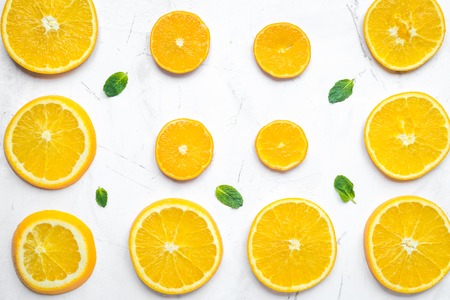Orange slices with mint on white background top view patternの写真素材