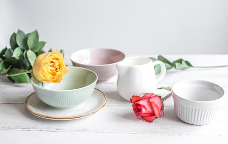 Ceramic tableware with flowers on white table