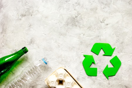 recycling symbol with waste on gray background top view mock upの写真素材