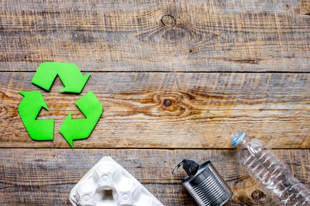 waste recycling symbol with garbage on wooden background top view mock-upの写真素材