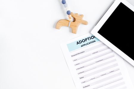 Adoption concept with tablet and drawing on white background top view mock-upの写真素材