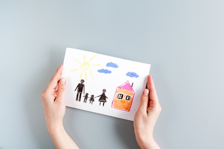 happy family concept with card and hands on gray desk background top view mock upの写真素材