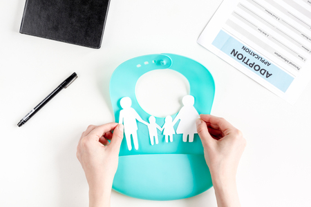 family paper figures in adopting concept on white background top viewの写真素材