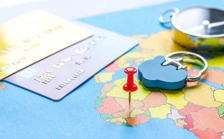 Travel preparation and booking with credit cards on touristic map background