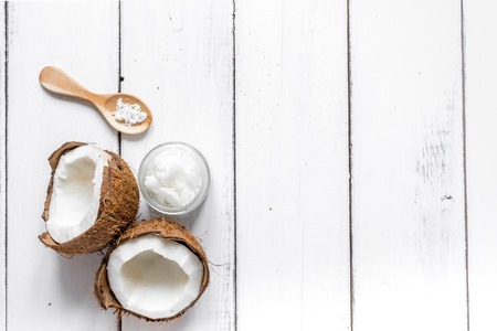 organic cosmetic concept with fresh coconuts and body cream on white table background top viewの写真素材