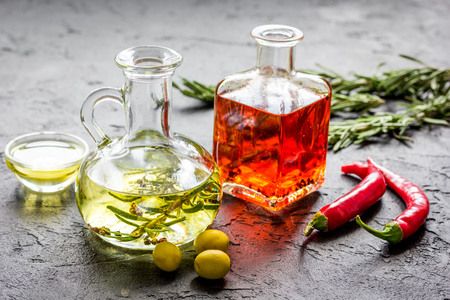 natural oils concept with fresh olives and chili paper on table backgroundの写真素材