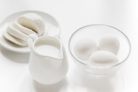 fresh dairy products for proteic meal on white table background