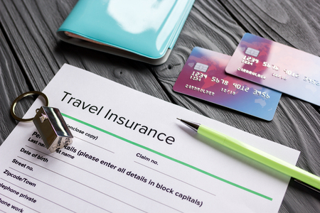 Travel insurance application form on wooden desk backgroundの写真素材