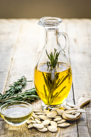 pumpkin seed oil with ingredients on kitchen table backgroundの写真素材