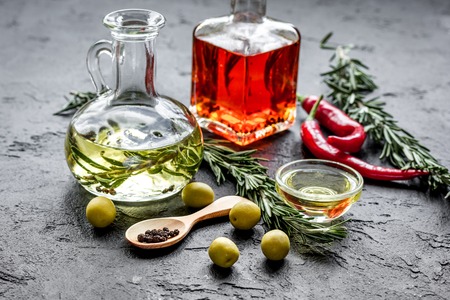 natural oils concept with fresh olives and chili paper on table background