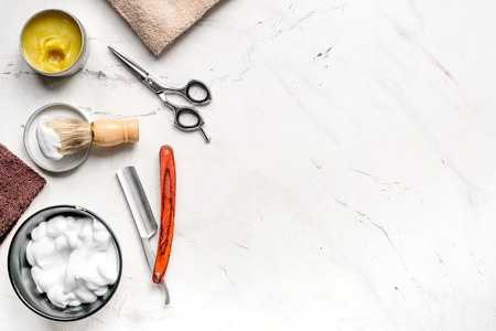 Tools for cutting beard in barbershop on workplace background top view mockupの写真素材