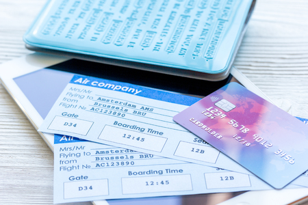 travel concept with passport, credit cards and flight tickets on light wooden table backgroundの写真素材