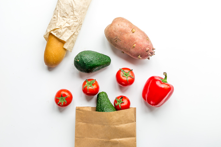 natural food set with fresh vegetables and baguette on white table background top view mock-upの写真素材