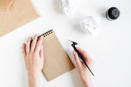writer tools with hands in profession concept on white desk background top viewの写真素材