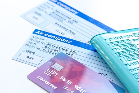 travel concept with passport, credit cards and flight tickets on light table