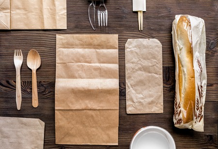 Take away set with paper bags on restourant table background top viewの写真素材