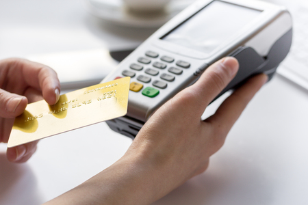 Credit card payment for business lunch in cafe on white backgroundの写真素材