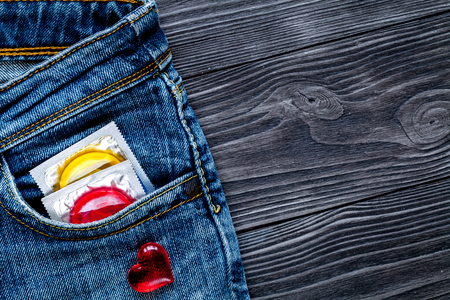 concept male contraception condom in jeans pocketの写真素材