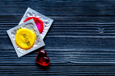 concept male contraception condom on wooden background top view.の写真素材