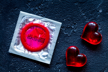 concept male contraception condom on dark background top view.の写真素材