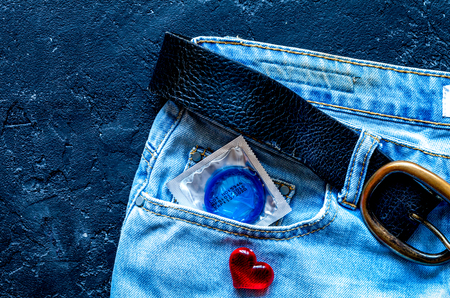 concept male contraception condom in jeans pocket top view.の写真素材