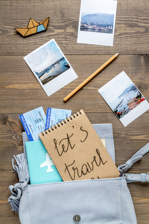 tourist stuff with photos and tickets on wooden background top viewの写真素材
