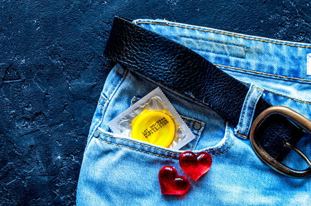 concept male contraception condom in jeans pocket top viewの写真素材