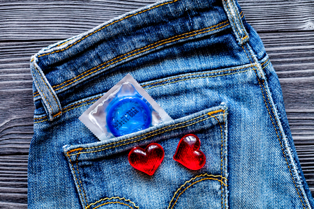 concept male contraception condom in jeans pocketの写真素材