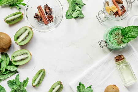 Cosmetic for body with kiwi scrub table background top view mockupの写真素材